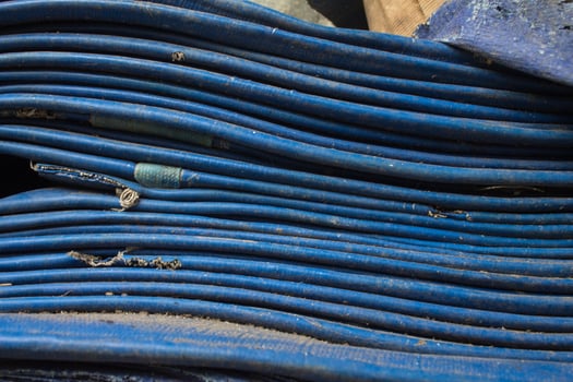 pile of used blue rubber hoses photo