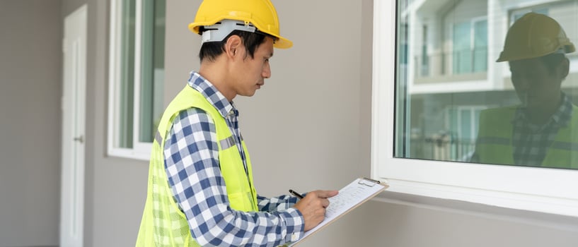 inspector or engineer is inspecting construction and quality assurance new house using a checklist. Engineers or architects or contactor work to build the house before handing it over to the homeowner photo
