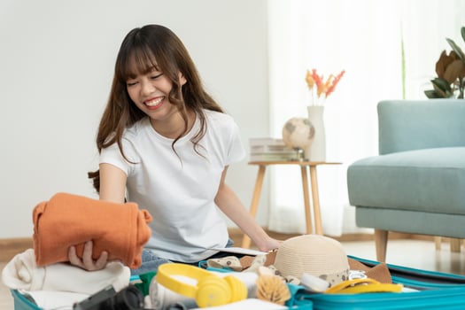 Travel bag. female are checking the detail and quantity of items used during the trip. Young women are prepare clothes and personal belongings. Pack your luggage before travel. photo