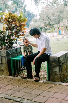 A father and his child sitting and chatting in a city square photo