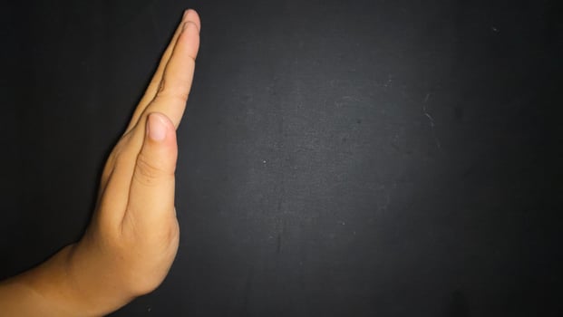 Hand by showing a stop or warning gesture.Isolated on black background photo