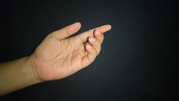 Hands with a gesture asking for help. Isolated on black background photo