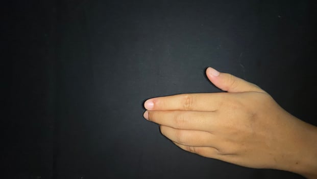 Offering a hand in a gesture inviting a handshake. Isolated on black background photo