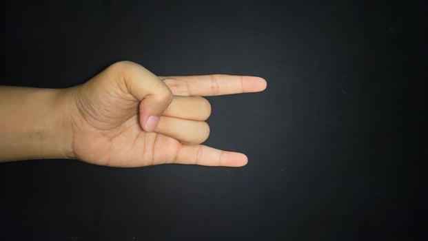 Rock hand sign isolated black background photo