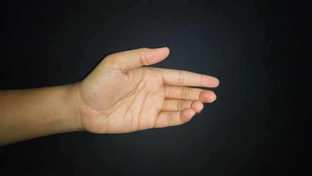 Hands show a gesture of giving help. Isolated on black background photo