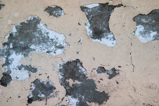 Old cracked paint on the concrete wall. Peeling paint on wall texture photo