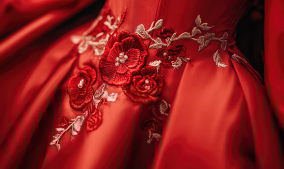 A red dress with flowers embroidered on it photo