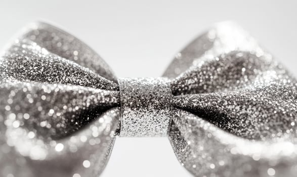 A silver bow with glitter on it photo