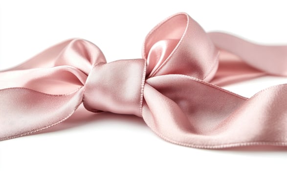 A pink ribbon is tied in a bow photo