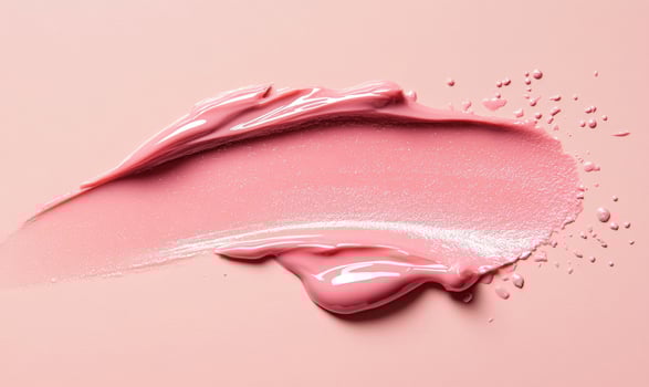 A pink lip gloss is shown with a white background photo