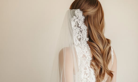 A woman with long blonde hair is wearing a white lace veil photo