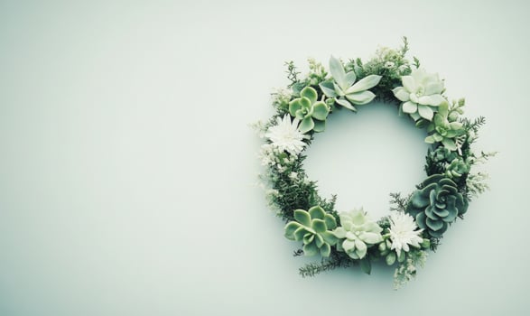A wreath made of green plants and white flowers photo