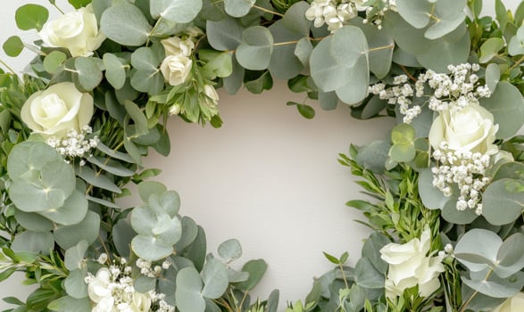 A wreath made of white flowers and green leaves photo