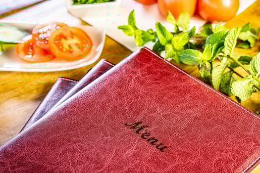 Menu restaurant fresh tomatoes with mint and basil on wooden table over bokeh background photo