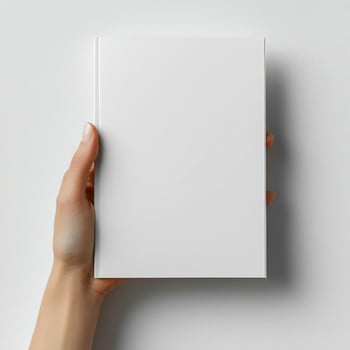 A woman hand holding a white magazine on a white background photo