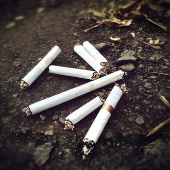 Unhealthy habit Tobacco Addiction Smoked cigarette ash waste on the ground photo