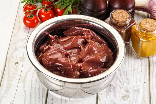 Raw chicken liver uncooked in the bowl photo