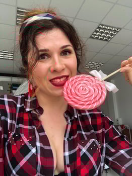 Young woman in retro pinup vibes with a sweet twist lollipop. Playfulness, retro charm and vintage aesthetic photo