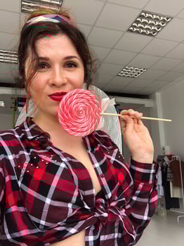 Young woman in retro pinup vibes with a sweet twist lollipop. Playfulness, retro charm and vintage aesthetic photo