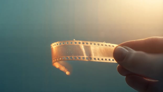 A person holding a film strip in their hand photo