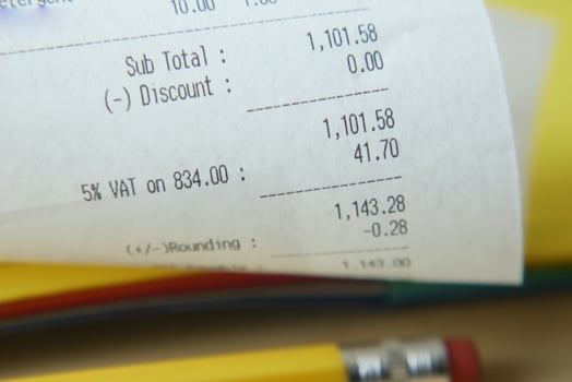 A receipt, coins, and a pencil on a table symbolize finance, transactions, and commerce photo
