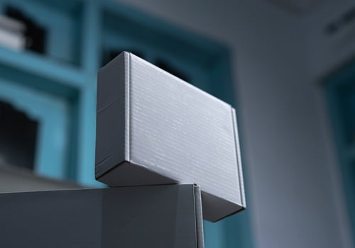 A white box sitting on top of another white box in a room photo