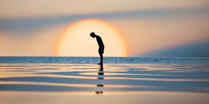 A man standing on a beach with his arms outstretched photo