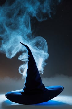 Blue mist surrounds a magical witch's hat in the night. photo
