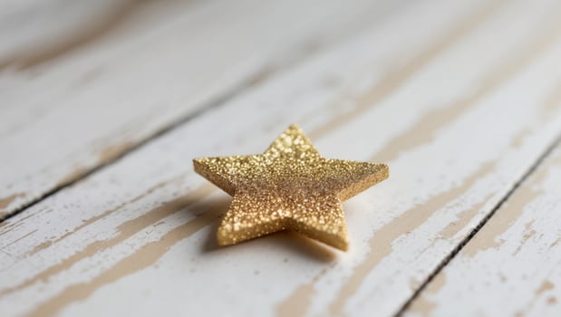Gold Glitter Star on Whitewashed Wood Background. photo