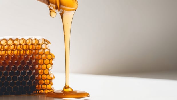 Golden Honey Dripping Through a Honeycomb. photo