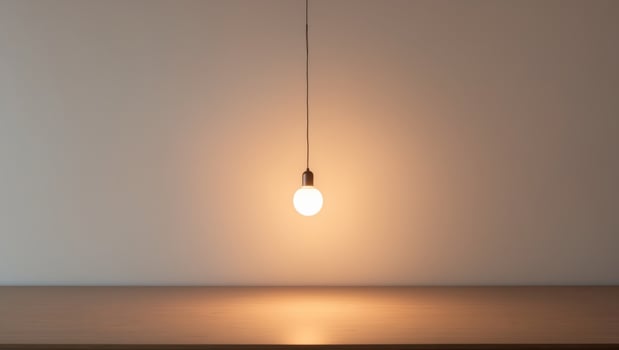 Illuminated Wooden Surface with Hanging Light Bulb. photo