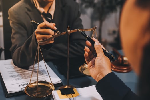 Judge gavel with Justice lawyers having team meeting at law firm background. Concepts of Law and Legal services. photo