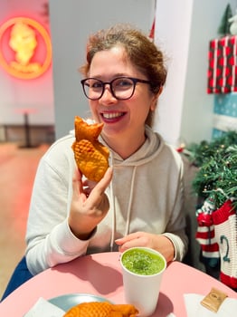 Woman with Japanese sweet taiyaki dessert. Freshly baked fish shaped waffle instead of filling adding ice cream. Winter and Christmas holidays sweets photo