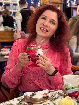Happy Woman Eating Cake at Christmas Dinner Party - Smiling girl eating dessert at Xmas festivity photo