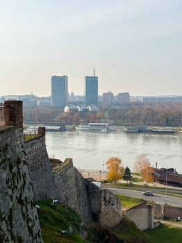 Looking across the Sava river in Belgrade, river boats in the foreground and a variety of office blocks in the distance. Belgrade in autumn season photo