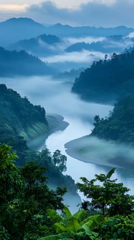 Serene Winding River Through Misty Green Mountains in Morning Light photo