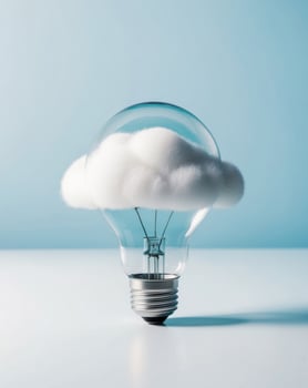 Cloud computing concept with light bulb on blue background photo
