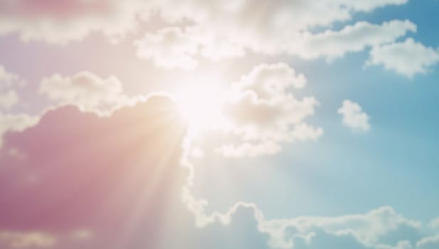 A pastelcolored abstract scene features a softly lit blurry sky with scattered clouds photo