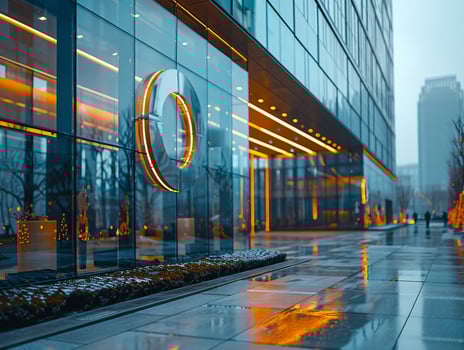 A glass logo displayed on a modern office building. photo
