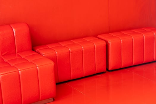 Red sofa in red background. Copy space. photo