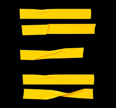 Top view set of wrinkled or crumpled yellow adhesive vinyl tape or cloth tape in stripes shape isolated on black background with clipping path photo