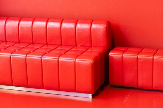Red sofa in red background. Copy space. photo