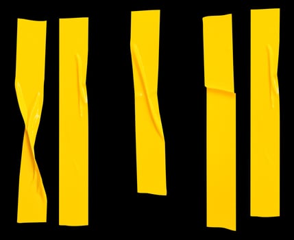 Top view set of wrinkled or crumpled yellow adhesive vinyl tape or cloth tape in stripes shape isolated on black background with clipping path photo