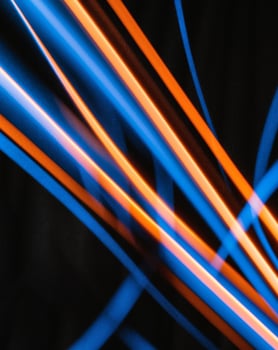 A blue and orange light line on a black background photo