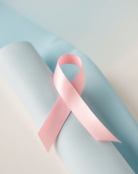 Pink Ribbon on Light Blue Surface for Awareness. photo