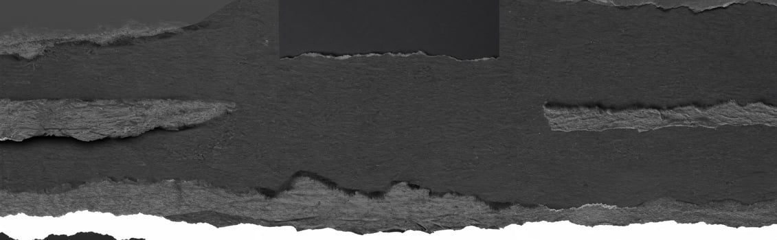 Close-up texture of torn black paper with a rough edge, perfect for background, design, or collage elements. photo