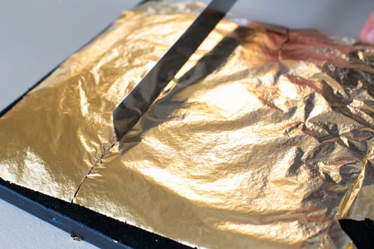 Gilding theme with a leaf of beaten gold and blade photo