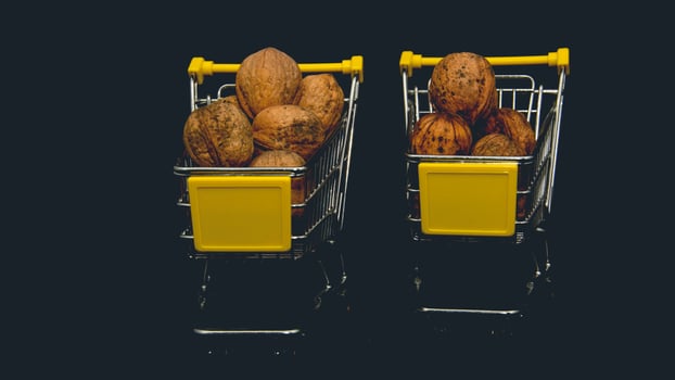 Two shopping carts filled with nuts on a black background photo