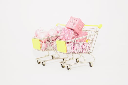 A shopping cart filled with pink and white presents photo