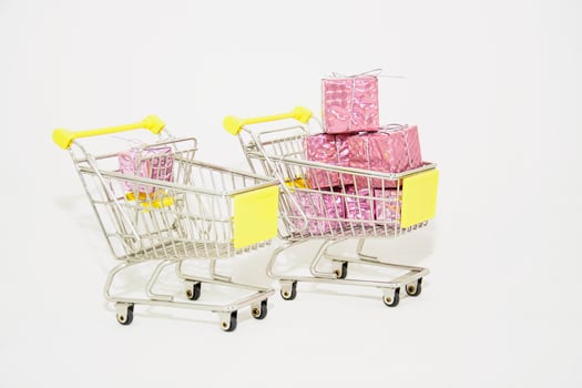 Two shopping carts with pink and yellow boxes photo
